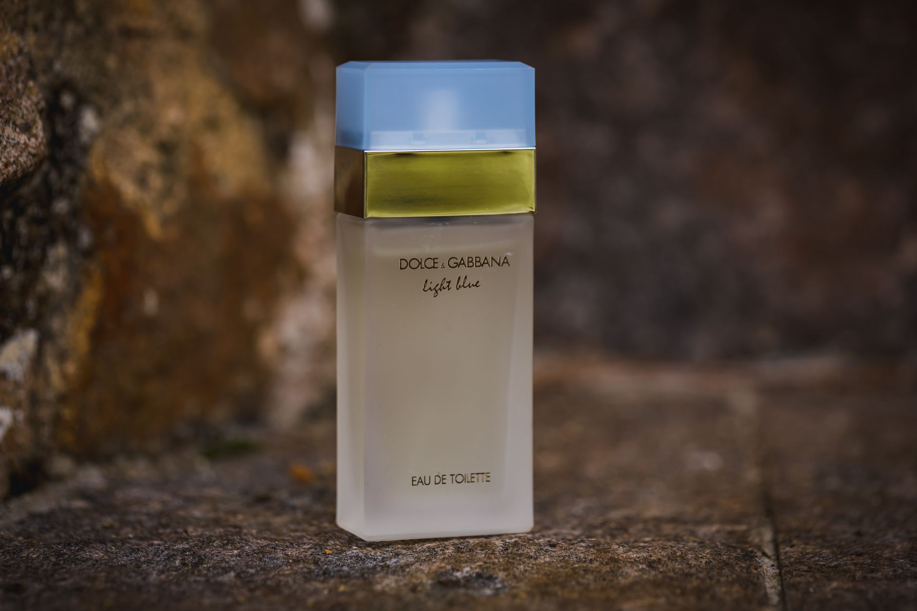 Elegant Dolce & Gabbana Light Blue perfume bottle on a textured background.
