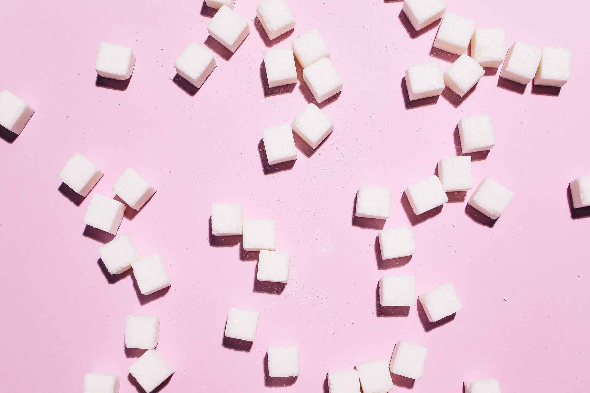 Bowl of white sugar cubes illustrating how sugar affects skin and hair